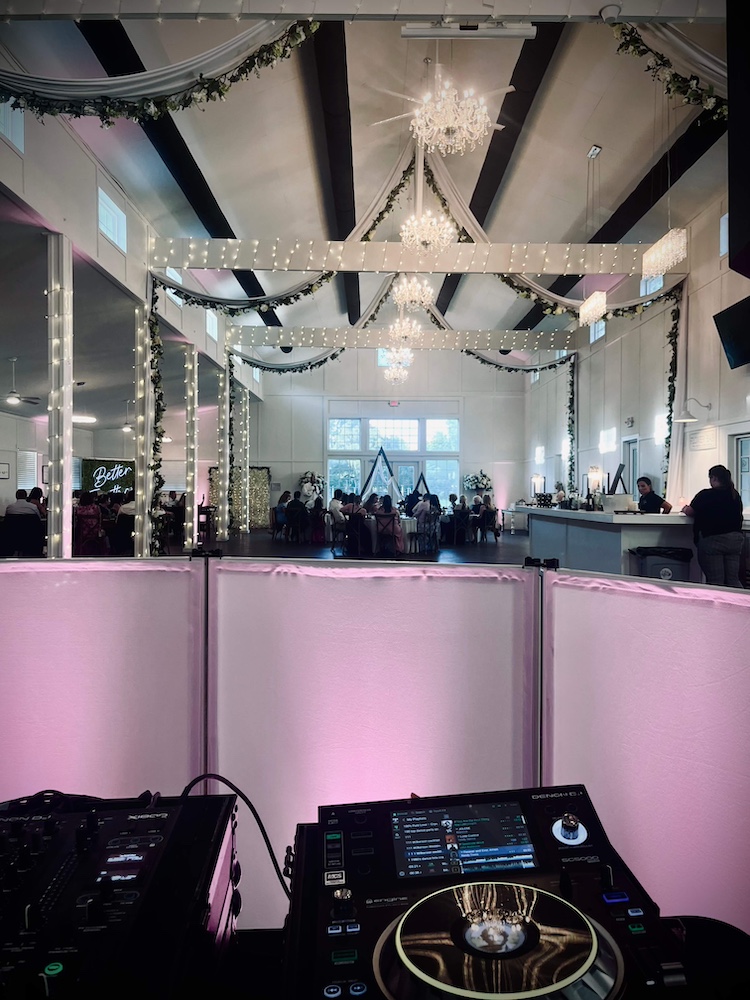 DJ decks, uplighting and facade overlooking the dance floor at a wedding by Tampa Bay wedding dj, DJ DaHeart