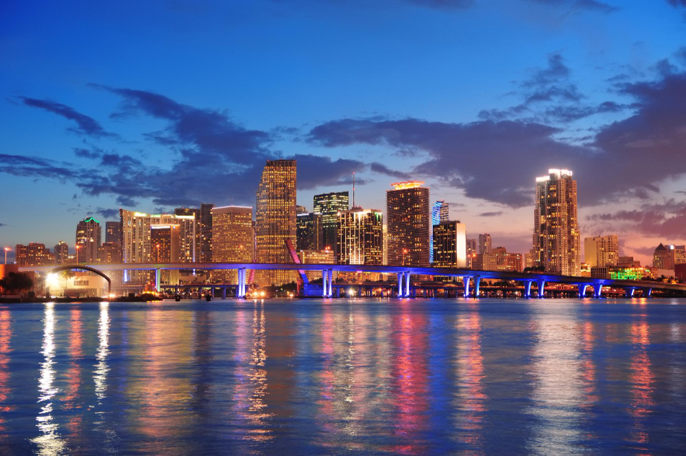 Miami skyline at night indicating DJ services for nightlife